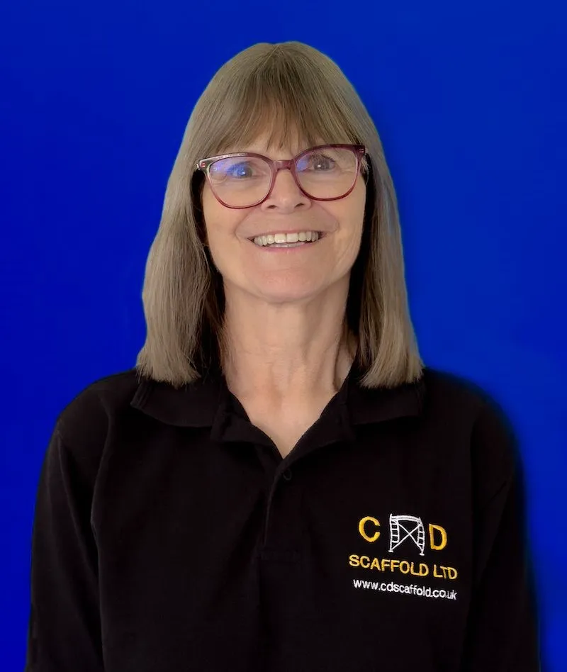 A woman wearing glasses and a black shirt.